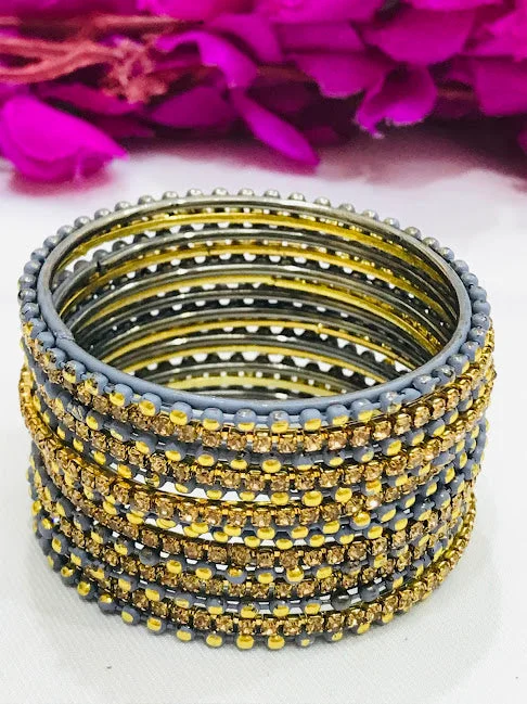 Bangles with pave-set diamonds for dazzle -Attractive Gray Colored Golden Stone Metal Bangles For Girls